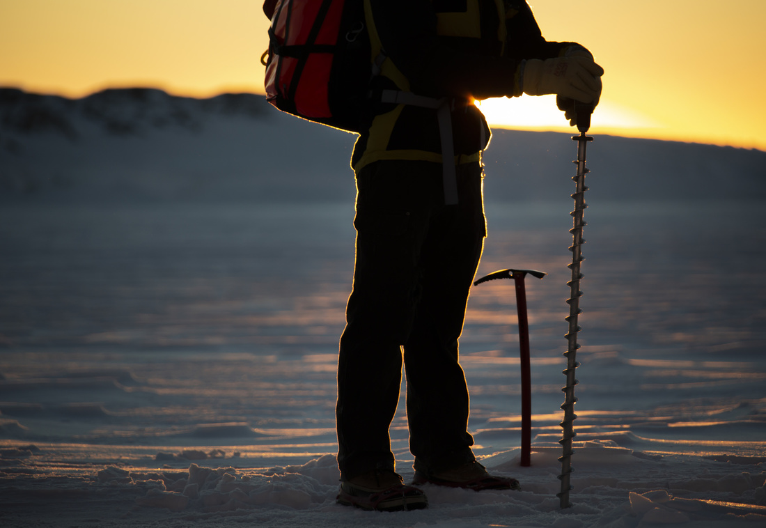 Taking sea-ice thickness measurements. Photo: Justin Chambers